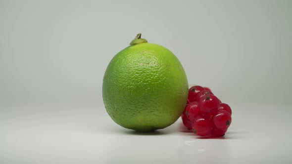 Freshly Picked Red Currants And Green Lime Rotating Clockwise - Close Up Shot