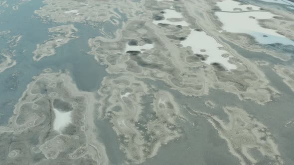 Beautiful flight in the afternoon over a frozen river, lake, ocean. Ice everywhere. Snow on ice.