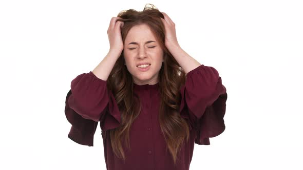 Studio Portrait of Annoyed Longhaired Woman Gesturing in Stress Expressing Irritation and Anger Over