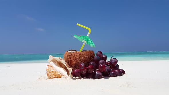 Wide angle flying travel shot of a paradise sunny white sand beach and aqua blue water background in