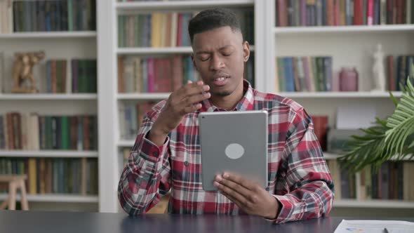 African Man Reacting to Loss on Tablet in Office