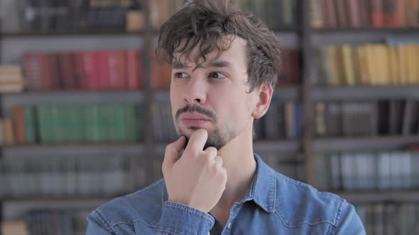 Portrait of Thinking Middle Aged Man in Office