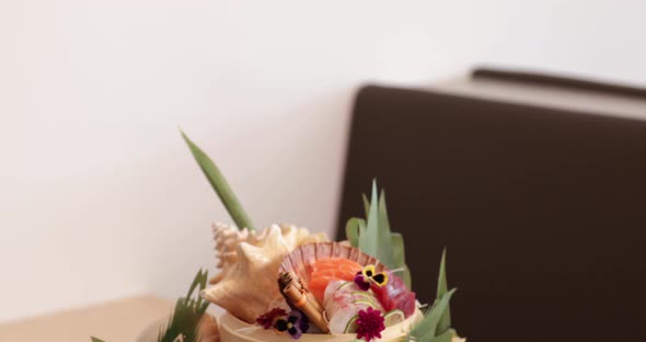 Sushi And Sashimi Rolls Arranged Creatively In A Plate In A Sushi Restaurant - tilt down shot