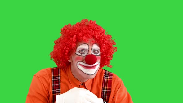 Funny Clown Having Some Hard Thinking on a Green Screen Chroma Key