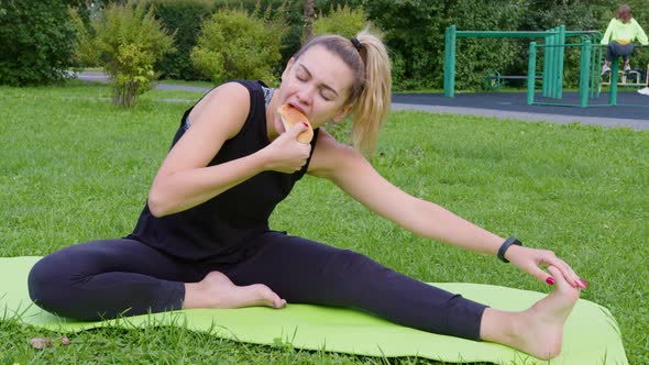 Girl Stretches on Exercise Mat and Bites Off Pie