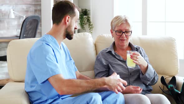 Senior Woman in Nursing Home Talking with Male Doctor