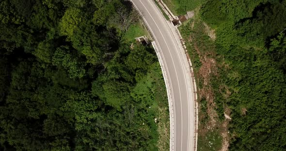 Aerial View From Drone of Curve Road with a Car on the Mountain with Green Forest in Russia