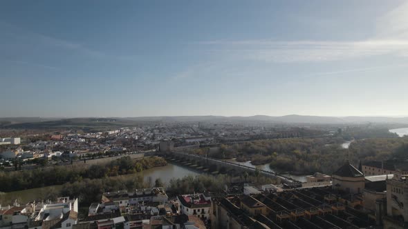 Aerial riser reveals historic sites of Cordoba - Roman bridge, Mezquita