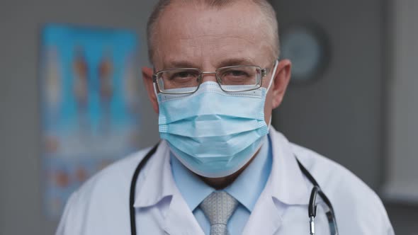 Successful Physician in White Lab Coat Looks at the Camera in Hospital Office