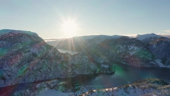 Big bright sun with massive sun rays setting over mesmerizing Veafjorden - Norway winter landscape p