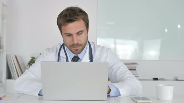 Pensive Doctor Sitting in Clinic and Thinking