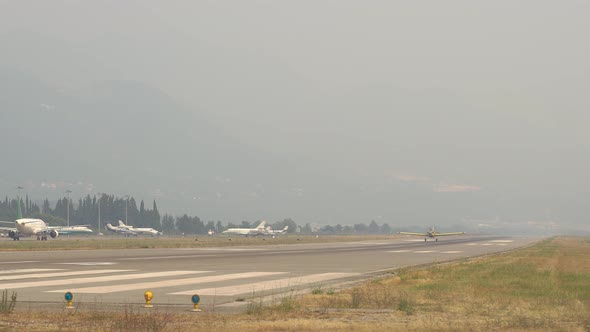 Lightengine Aircraft Takes Off From the Runway Shrouded in a Haze of Fires