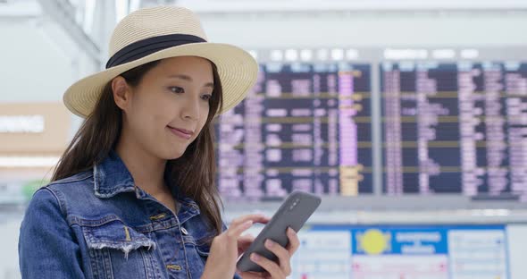 Woman use of mobile phone inside airport