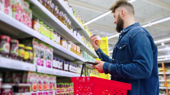 Man Buying Jam in the Supermarket