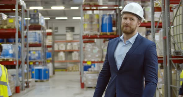 Smiling Warehouse Team with Boss in Large Warehouse