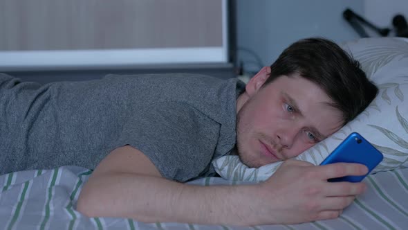 a Man Experiences a Feeling of Loneliness Lying on the Bed