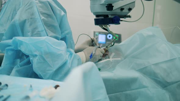 Doctor is Operating an Eye with Modern Equipment