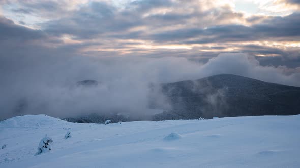 Moving mists over the snow-covered mountain slopes