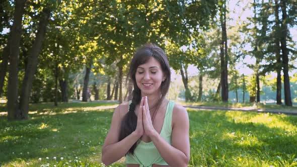 Young European Woman Sportswear Purple Mat Practicing Yoga Pose Park Green Lush Meadow City Park