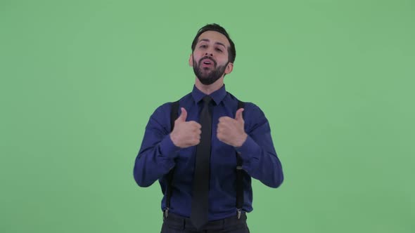 Happy Young Bearded Persian Businessman Giving Thumbs Up and Looking Excited