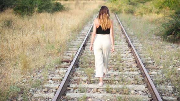  Trendy Young Woman Walking on the Rail Track.