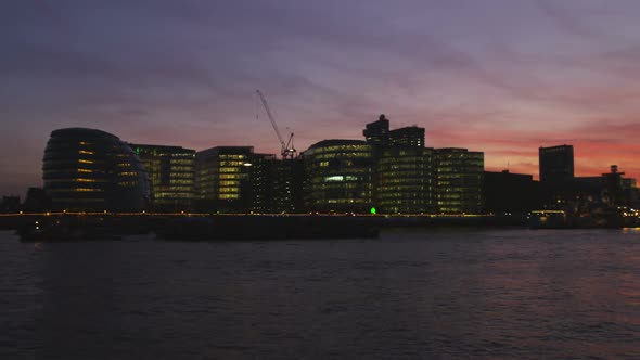 Pan of London cityscape after sunset.