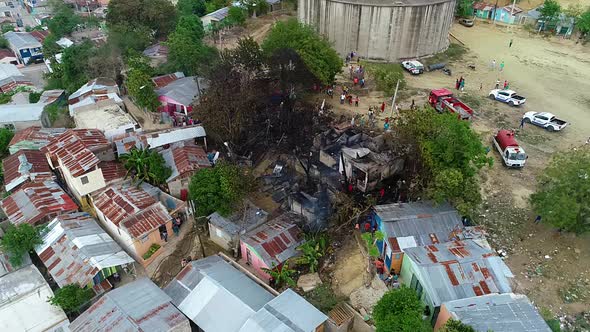 Aerial view around firefighters and people at a burnt building fire, in the slums of Mexico city, Ce