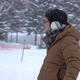 Asian Man In Winter Clothes Standing Under Snow Fall - VideoHive Item for Sale