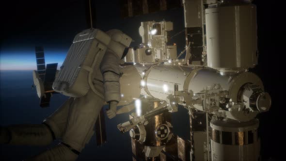 International Space Station and Astronaut in Outer Space Over the Planet Earth alt