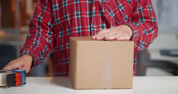 Cropped Shot of Online Seller Work at Office and Pack Shipping Delivery Box to Customer