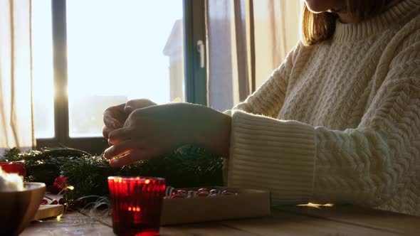 Woman Making Fir Christmas Wreath at Home