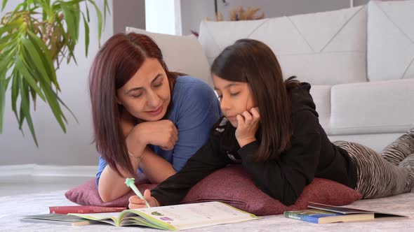 A mother helping her child's lesson.