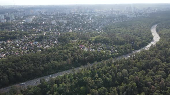 Megalopolis Next To the Forest: the Contact Between the Big City and Nature. Aerial View. Slow