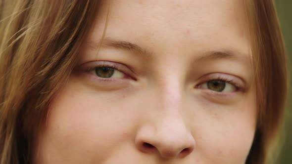 Natural Beauty Concept. Close Up Shot of Caucasian Woman with Beautiful Green Eyes and Frekles