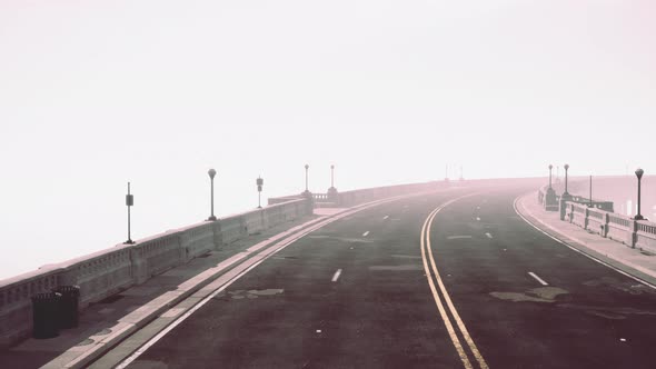 Illuminated Empty Road Bridge in a Fog