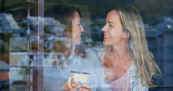 Woman Having Coffee While Her Partner Hugging from Back 4k