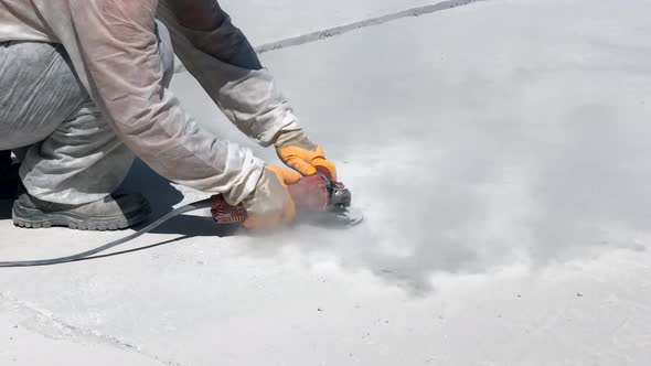 Hands of Worker Grinding Concrete Surface