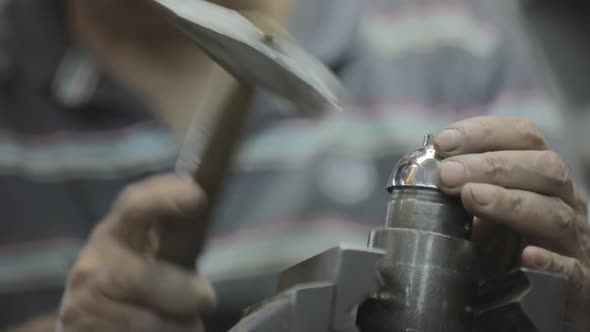 Silver work jeweler make Judaica silver cup, hammer dents. hand work, close-up