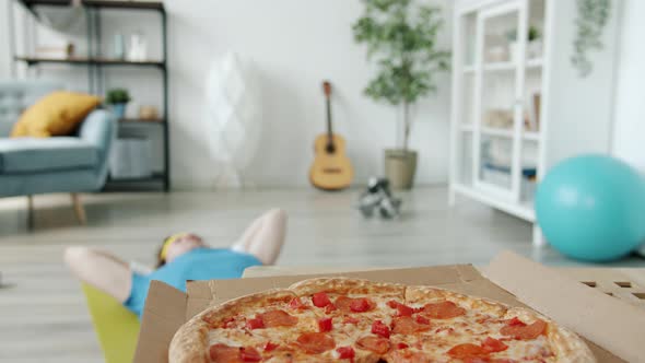 Portrait of Funny Male Athlete Doing Crunches Then Eating Pizza Enjoying Fast Food