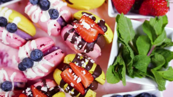 Handmade Beautiful Macaroon Dessert with Fresh Strawberries and Blueberries Decorated with Chocolate