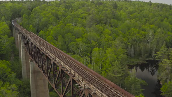 Onawa trestle bridge slow aerial high over woods