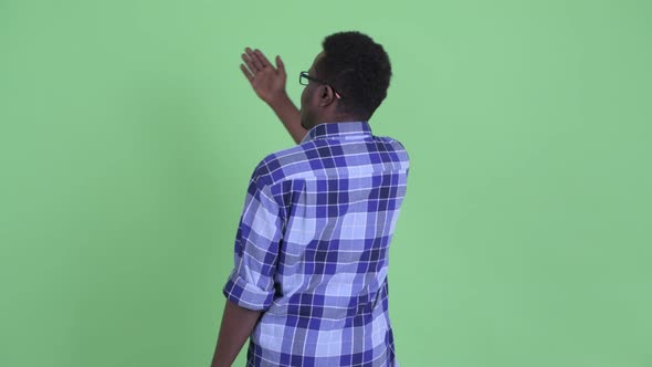 Rear View of Happy Young African Hipster Man Looking Around