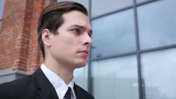 Confident Successful Businessman  Leaving Office Building