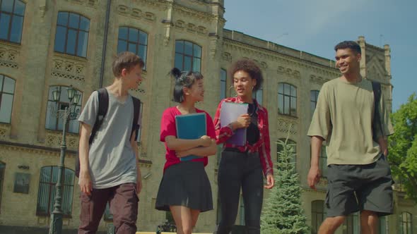 Diverse Multiracial College Friends Walking After Lesson at University Campus