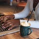 African American Woman Hands in Cafe with Coffee Working on Laptop Typing - VideoHive Item for Sale