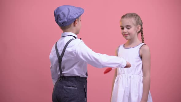 Little Boy Giving Red Heart-Shaped Lollipop to Girlfriend, Sweet Romantic Gift