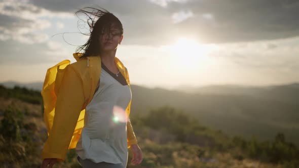 A Caucasian Woman is Hiking on a Mountain Top