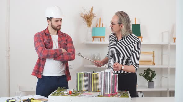 Young Engineer Man Mastering New Knowledge By Professional Architect