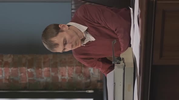 Man Working at Desk with Vintage Typewriter