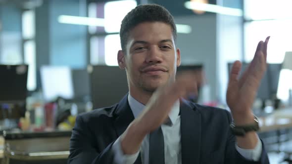 Portrait of African Businessman Clapping in Modern Office